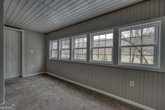 carpeted spare room with baseboards