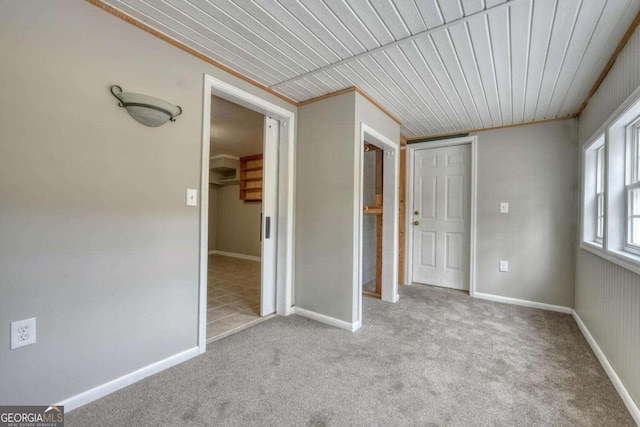 unfurnished bedroom with carpet, a closet, and baseboards
