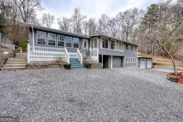 view of front facade with driveway and stairs