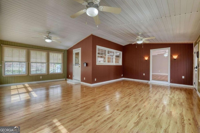 unfurnished living room featuring light wood finished floors, baseboards, lofted ceiling, and ceiling fan