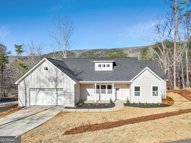 modern inspired farmhouse with driveway, a porch, a shingled roof, a garage, and board and batten siding