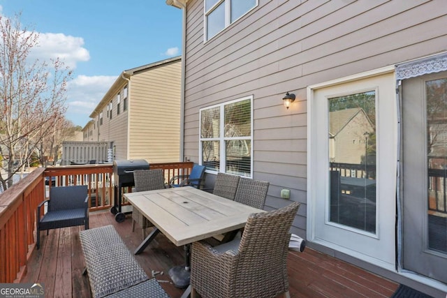 wooden terrace featuring outdoor dining space