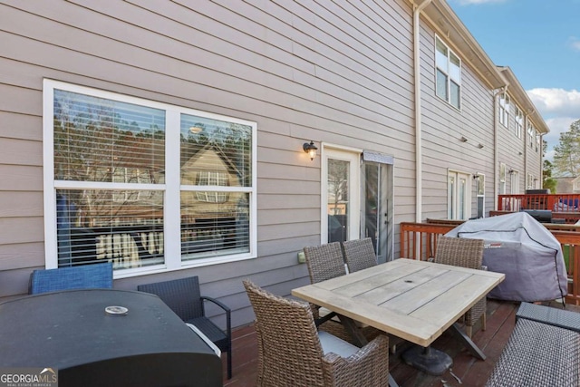 deck featuring outdoor dining space and area for grilling