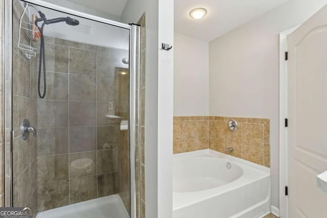 full bath featuring a garden tub and a stall shower