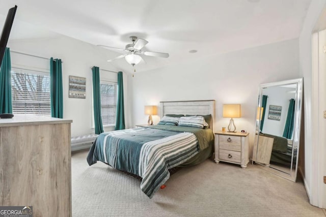 bedroom featuring light carpet, ceiling fan, and vaulted ceiling