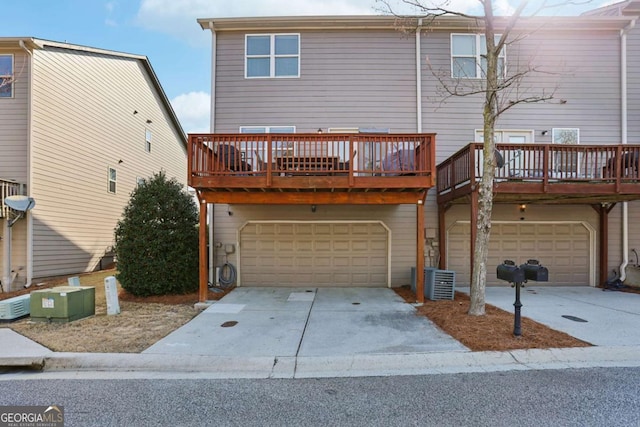 exterior space with a deck, concrete driveway, and an attached garage