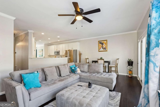 living area featuring baseboards, dark wood finished floors, recessed lighting, ceiling fan, and crown molding