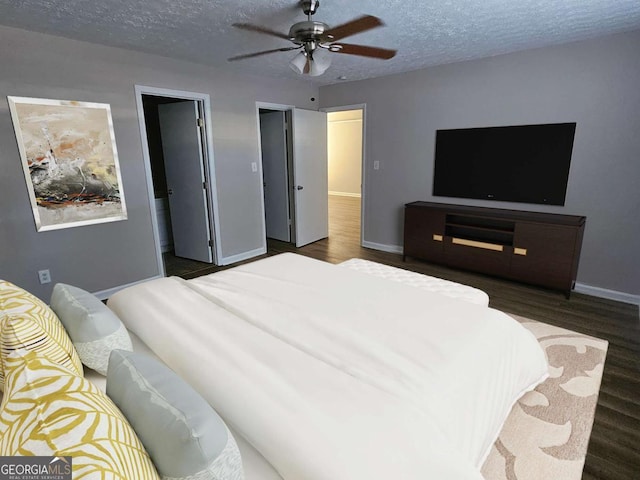 bedroom featuring a textured ceiling, a ceiling fan, baseboards, and wood finished floors