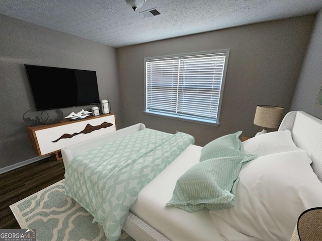 bedroom featuring visible vents, a textured ceiling, and wood finished floors