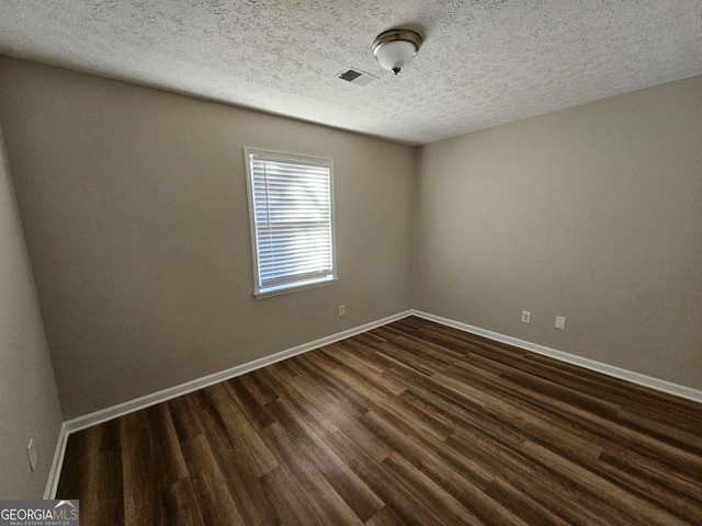 432 Independence Dr, Jonesboro, GA 30238 - empty room with baseboards, dark wood-type flooring, and visible vents