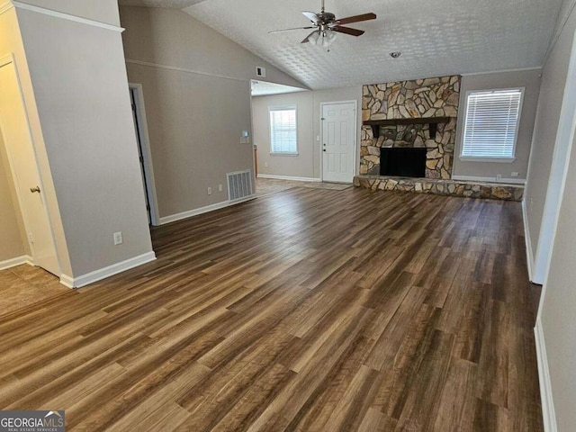 unfurnished living room with lofted ceiling, wood finished floors, visible vents, and ceiling fan