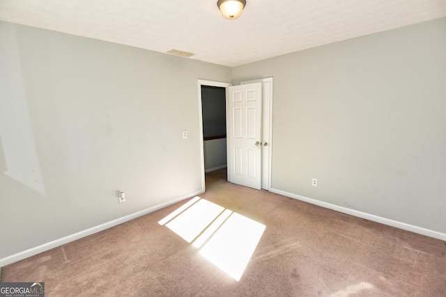 unfurnished bedroom featuring baseboards, visible vents, and carpet floors