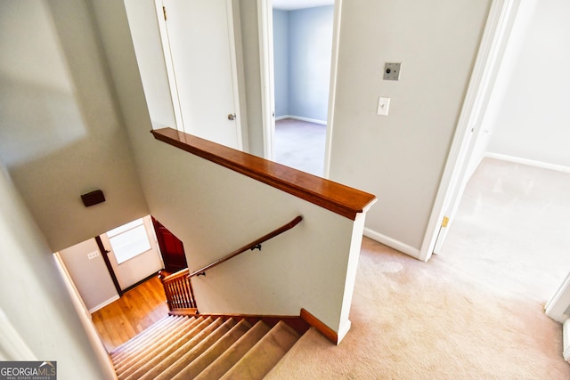 stairs with baseboards and carpet floors