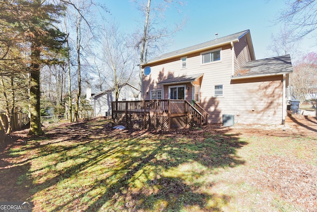 rear view of property featuring a wooden deck and fence