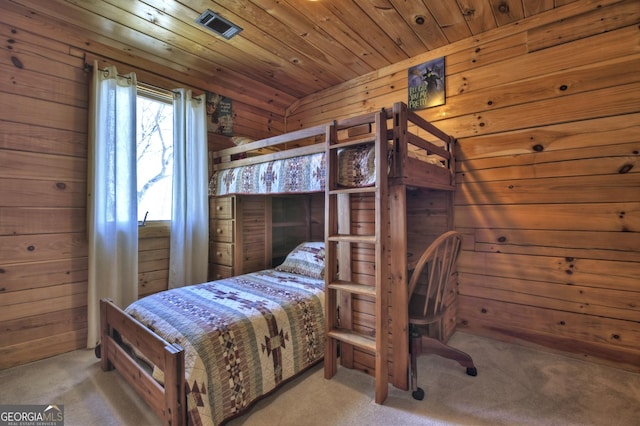 carpeted bedroom featuring wooden walls and wooden ceiling