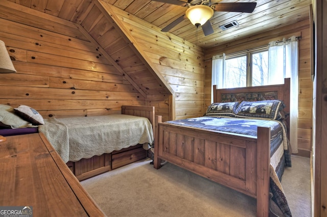 bedroom featuring wooden walls, carpet flooring, wood ceiling, and visible vents