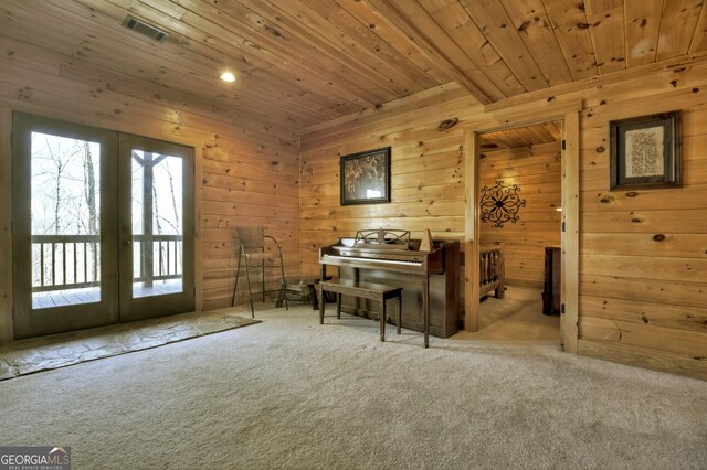 sitting room with french doors, carpet, visible vents, and wooden ceiling