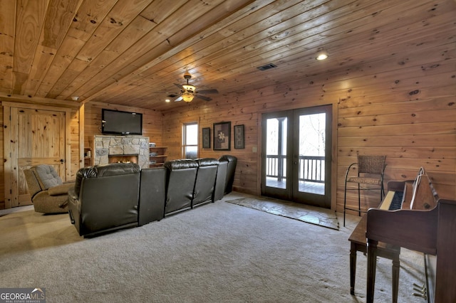 interior space featuring a ceiling fan, visible vents, carpet floors, french doors, and wooden ceiling