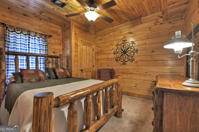 bedroom with carpet flooring, wood walls, wood ceiling, and visible vents