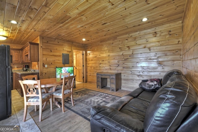 dining space featuring electric panel, wood ceiling, wood walls, and recessed lighting