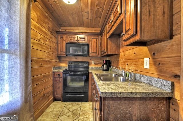 kitchen featuring a sink, wooden walls, and black appliances