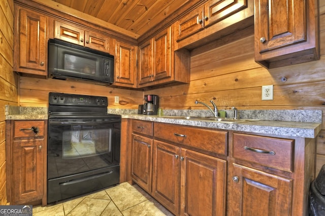 kitchen with a sink, black appliances, light countertops, wood walls, and wooden ceiling