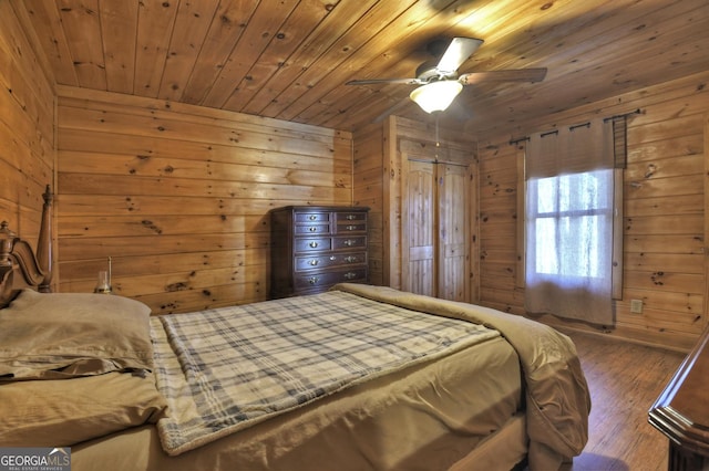 bedroom featuring wooden walls, wood finished floors, and wooden ceiling