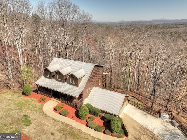 birds eye view of property featuring a view of trees