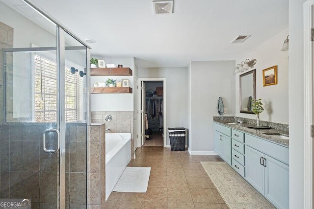 full bathroom featuring visible vents, a shower stall, a garden tub, and double vanity