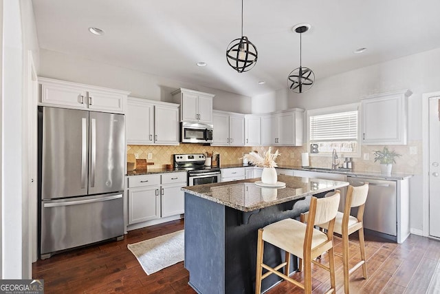 kitchen featuring white cabinets, dark wood-style floors, appliances with stainless steel finishes, and a sink