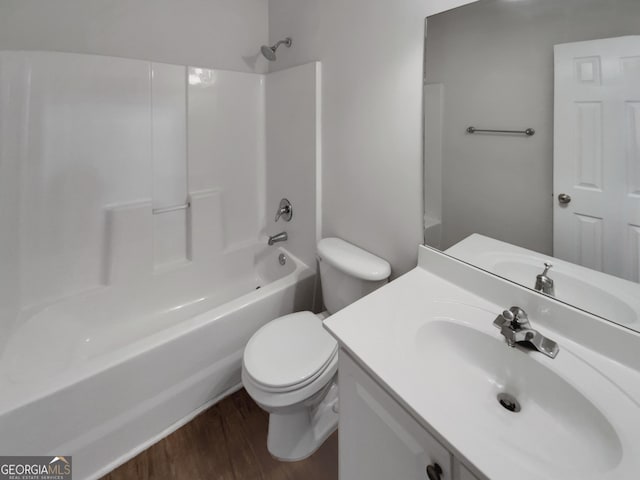 full bathroom with toilet, wood finished floors, vanity, and shower / tub combination