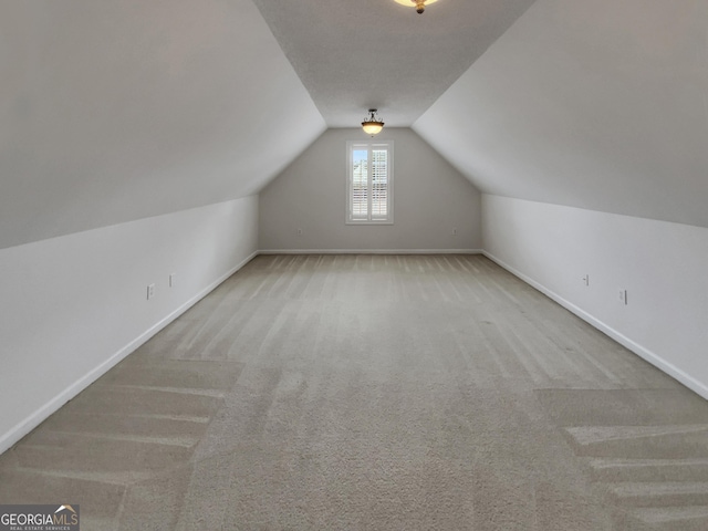 bonus room with baseboards, carpet floors, and lofted ceiling