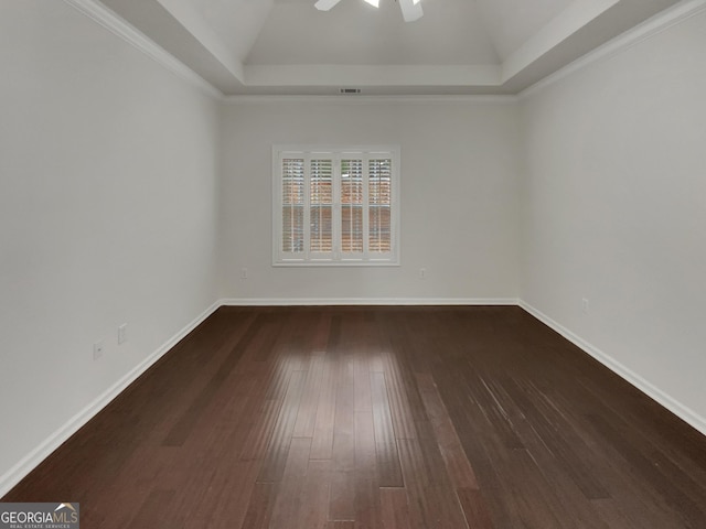 unfurnished room featuring visible vents, ceiling fan, baseboards, a tray ceiling, and wood finished floors