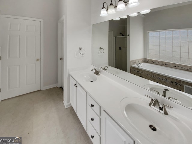 bathroom with a garden tub, a stall shower, and a sink