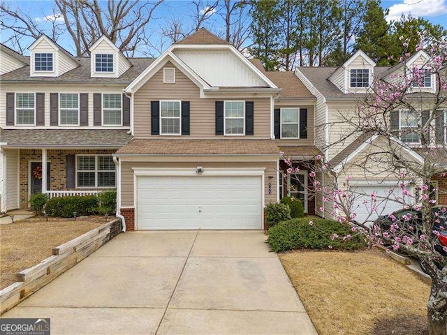 multi unit property with brick siding, covered porch, an attached garage, and concrete driveway