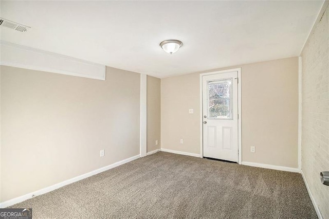 carpeted empty room with visible vents and baseboards