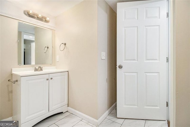 bathroom with vanity, baseboards, and marble finish floor