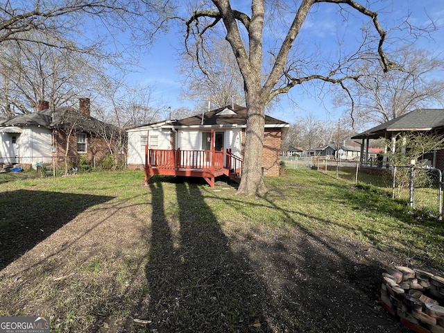 view of yard featuring a deck and fence