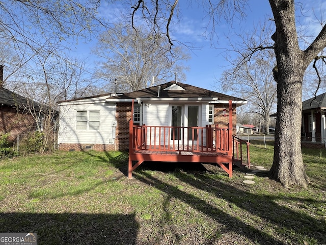 back of house featuring crawl space, a lawn, a deck, and fence