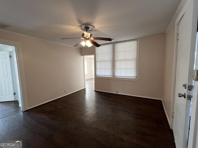 unfurnished room featuring visible vents, baseboards, dark wood-type flooring, and a ceiling fan