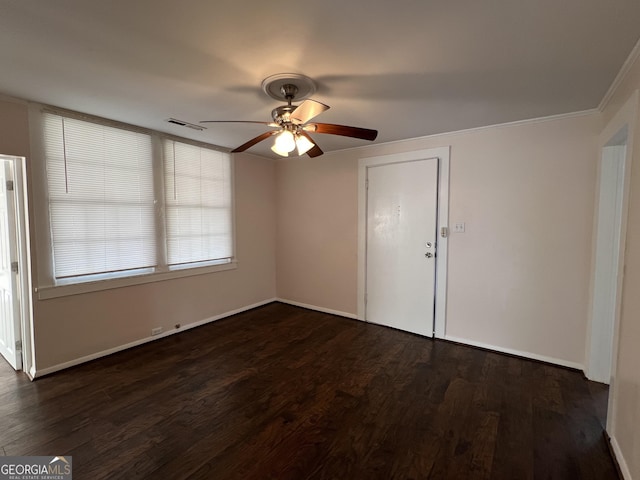 empty room featuring visible vents, baseboards, dark wood-type flooring, and a ceiling fan