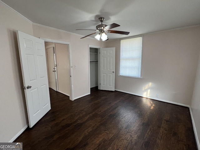 unfurnished bedroom with a closet, crown molding, baseboards, ceiling fan, and dark wood-style flooring