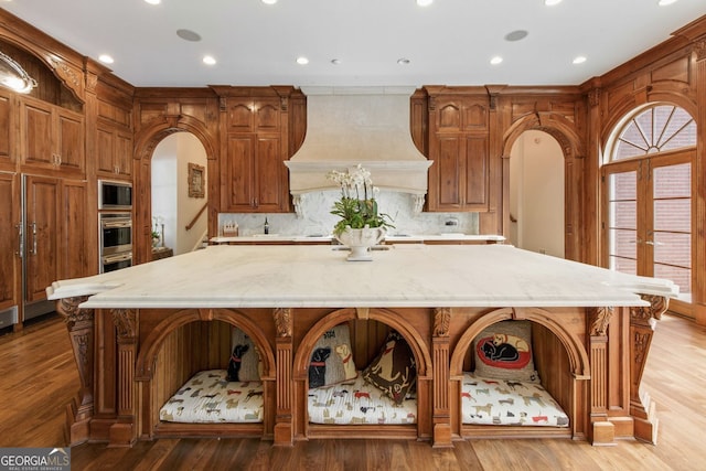 0 Winterthur, Sandy Springs, GA 30328 - kitchen featuring custom range hood, stainless steel appliances, a spacious island, arched walkways, and recessed lighting