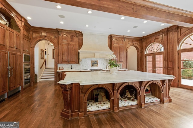 0 Winterthur, Sandy Springs, GA 30328 - kitchen with custom exhaust hood, arched walkways, dark wood-style floors, open shelves, and recessed lighting