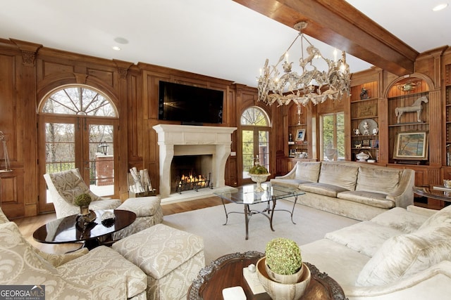 0 Winterthur, Sandy Springs, GA 30328 - living room with french doors, wood finished floors, built in features, a warm lit fireplace, and wooden walls