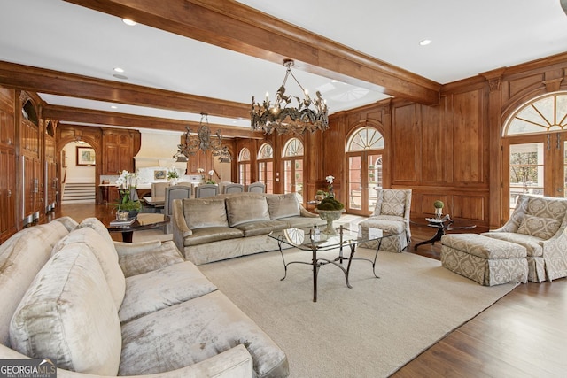 0 Winterthur, Sandy Springs, GA 30328 - living area with a chandelier, healthy amount of natural light, beamed ceiling, wood finished floors, and wooden walls