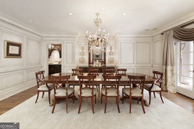 0 Winterthur, Sandy Springs, GA 30328 - dining space featuring a decorative wall, a chandelier, light wood finished floors, ornamental molding, and arched walkways