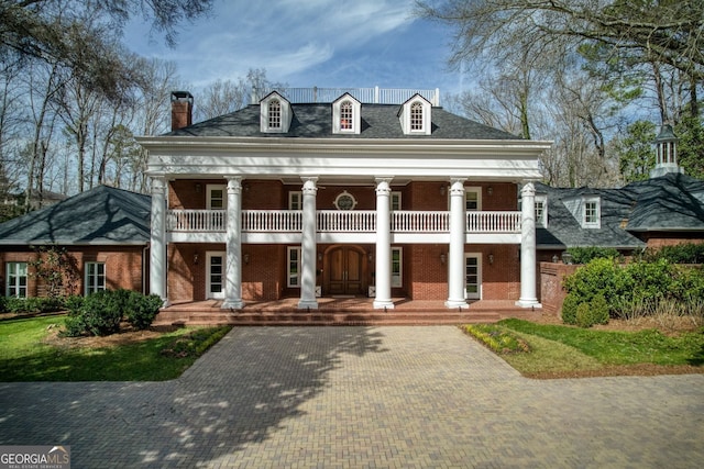 0 Winterthur, Sandy Springs, GA 30328 - greek revival house with a balcony, covered porch, a chimney, brick siding, and decorative driveway