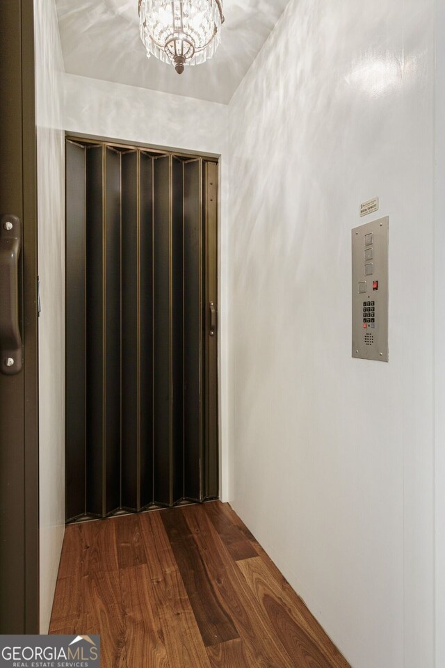 0 Winterthur, Sandy Springs, GA 30328 - corridor with dark wood finished floors and a chandelier