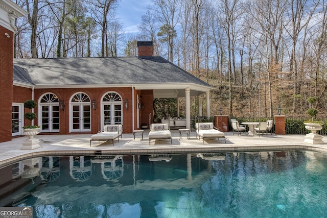 0 Winterthur, Sandy Springs, GA 30328 - swimming pool with french doors, a patio, and an outdoor structure